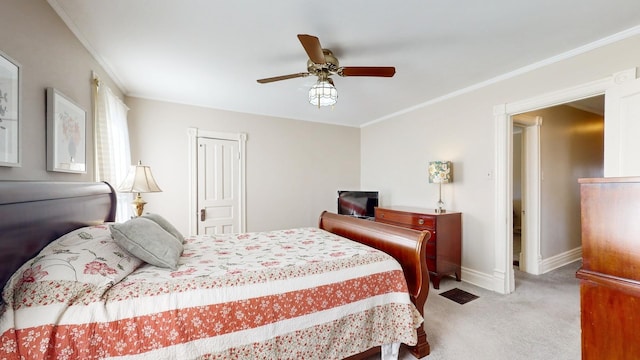 carpeted bedroom featuring crown molding and ceiling fan