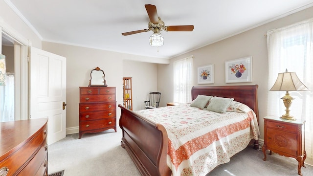 bedroom featuring multiple windows, ornamental molding, light carpet, and ceiling fan