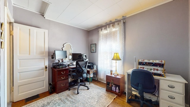 office space featuring ornamental molding and light hardwood / wood-style floors