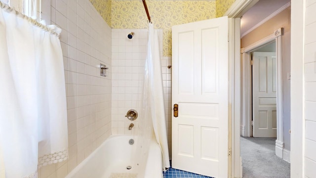 bathroom with ornamental molding and shower / bathtub combination with curtain