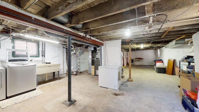 basement with sink and independent washer and dryer