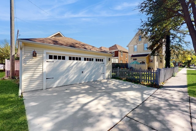 view of front of home with a garage and an outdoor structure