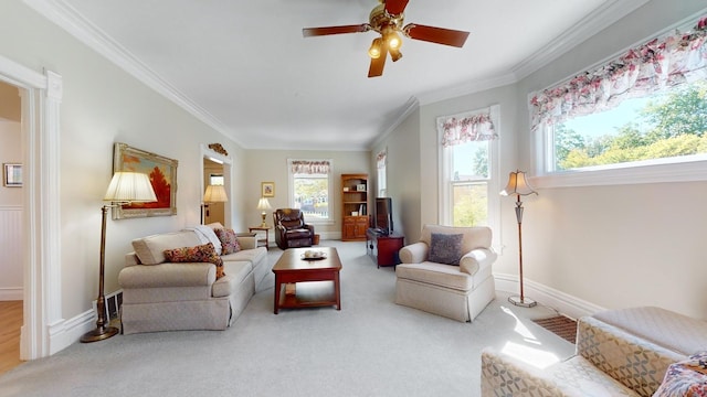 living room with crown molding, ceiling fan, and carpet flooring