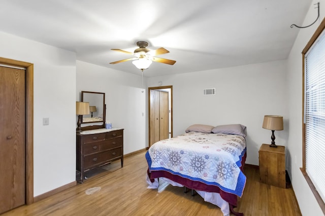 bedroom with ceiling fan and light hardwood / wood-style floors