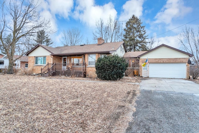 single story home with a garage and covered porch