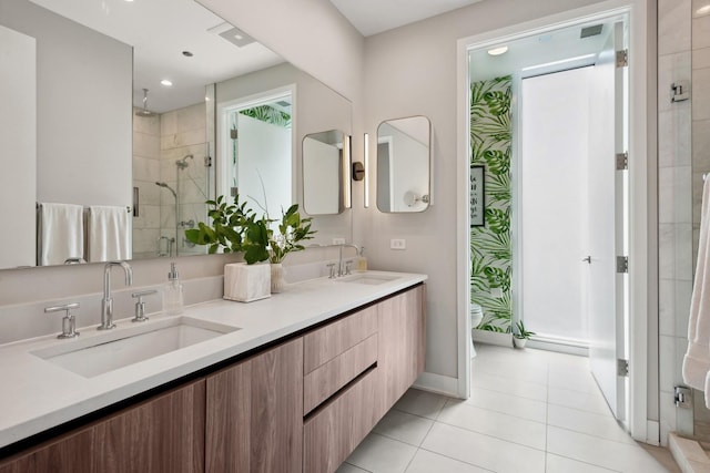 bathroom featuring toilet, tile patterned flooring, a shower with shower door, and vanity