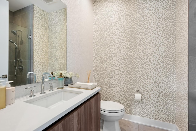 bathroom featuring vanity, a shower with shower door, tile patterned floors, and toilet