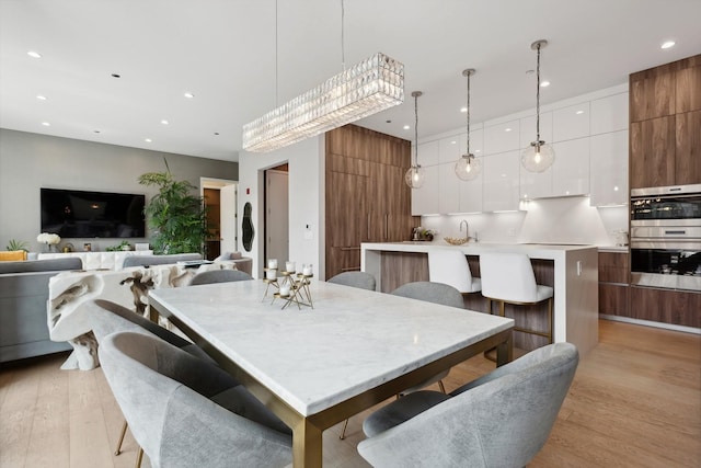 dining area featuring light wood-type flooring