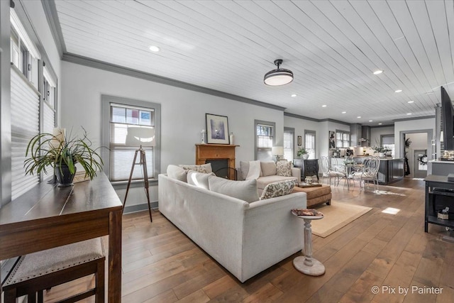 living room with ornamental molding, plenty of natural light, dark hardwood / wood-style flooring, and wooden ceiling