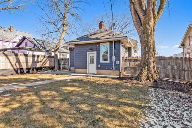 rear view of house featuring a yard