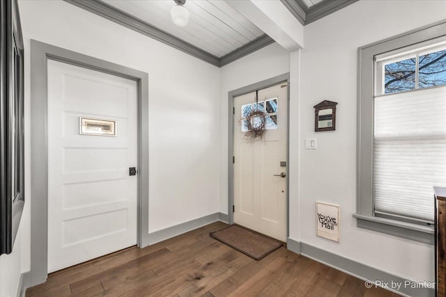 entrance foyer featuring crown molding, dark hardwood / wood-style flooring, and a wealth of natural light