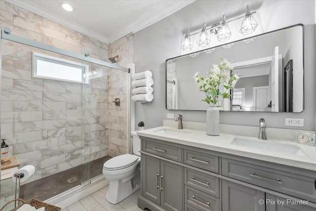 bathroom with vanity, crown molding, toilet, and tiled shower