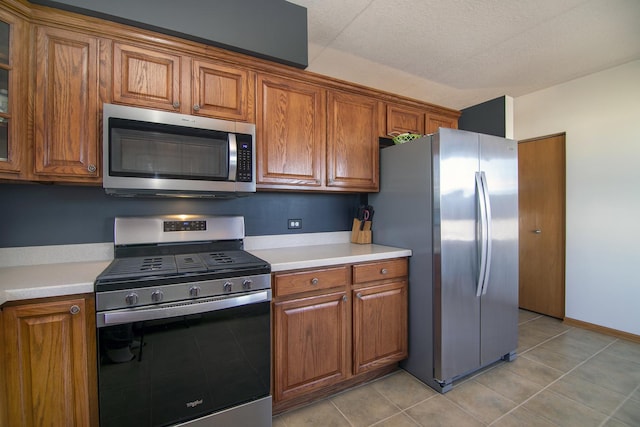 kitchen featuring appliances with stainless steel finishes and light tile patterned floors