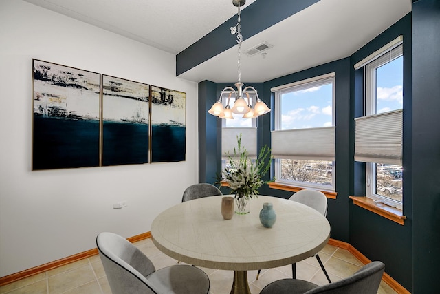 dining area featuring light tile patterned floors and a notable chandelier