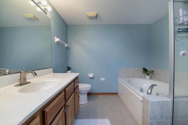 bathroom with vanity, tiled tub, tile patterned floors, and toilet