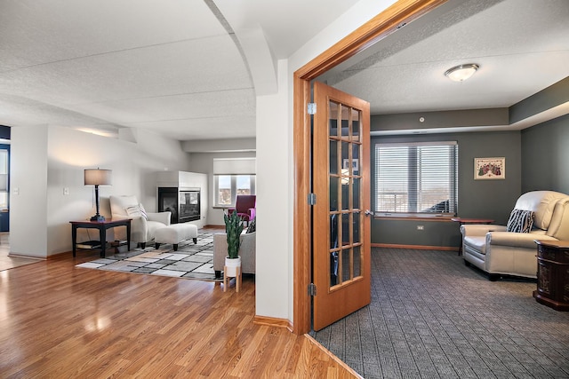 sitting room with hardwood / wood-style flooring and a textured ceiling