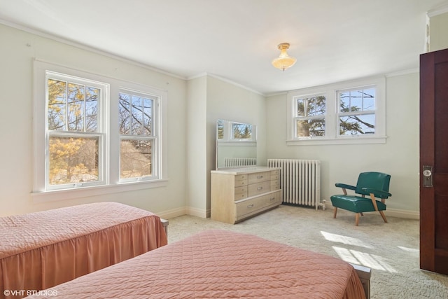 bedroom featuring baseboards, multiple windows, radiator heating unit, and light colored carpet