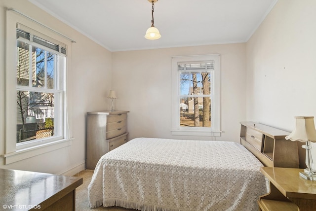 bedroom featuring ornamental molding, carpet, and baseboards