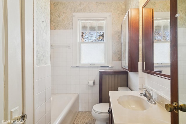 full bathroom with a bath, tile walls, toilet, and wallpapered walls