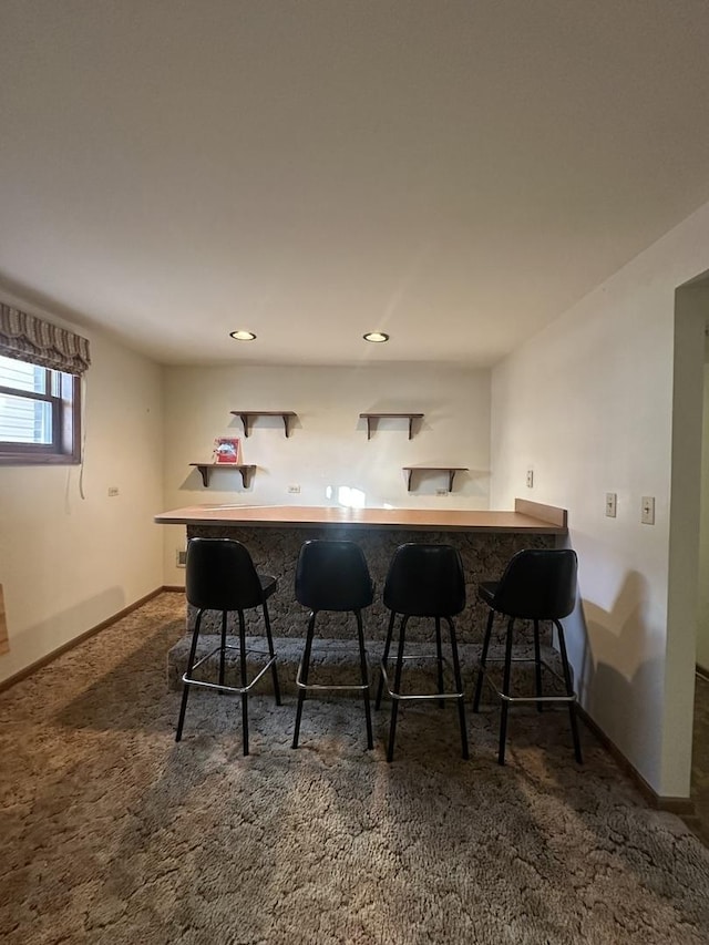 bar featuring dark colored carpet