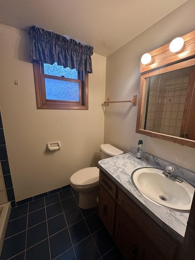 bathroom with vanity, tile patterned floors, and toilet