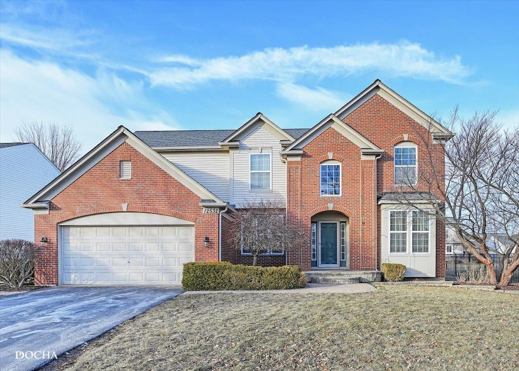 front of property with a garage and a front yard