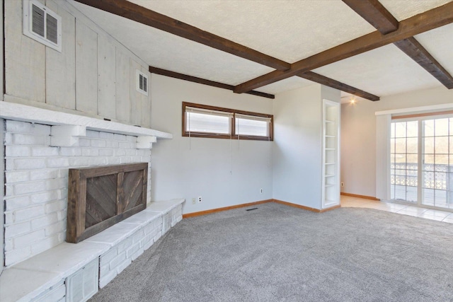 unfurnished living room featuring light carpet, wooden walls, beamed ceiling, and a fireplace