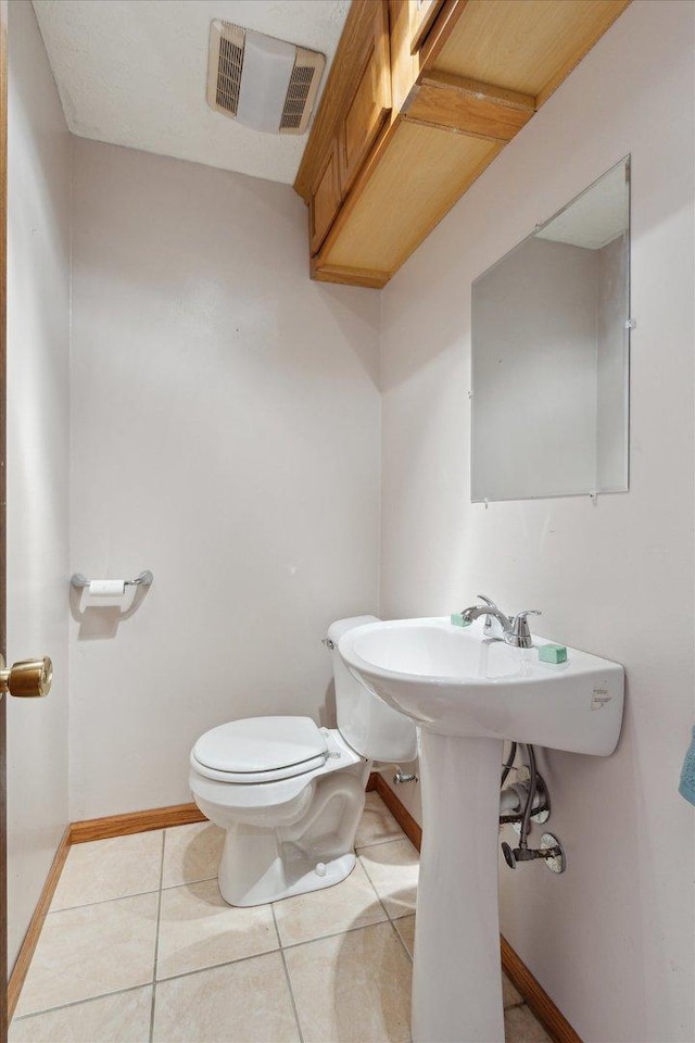 bathroom with tile patterned floors and toilet