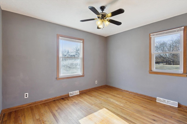 unfurnished room with light wood-type flooring and ceiling fan