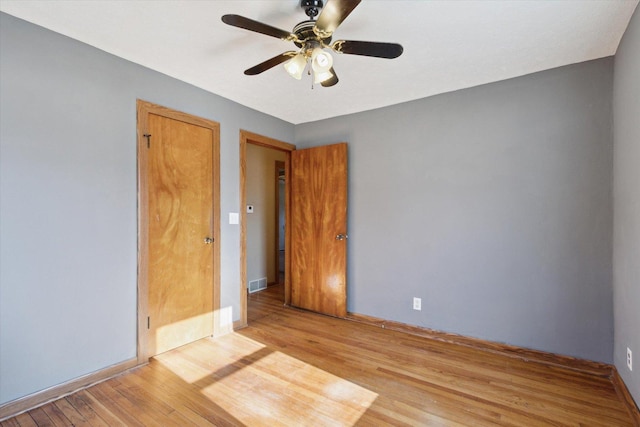 unfurnished room with ceiling fan and light hardwood / wood-style floors