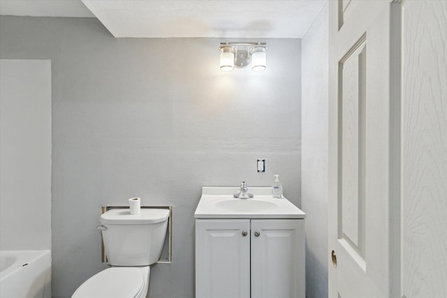 bathroom featuring toilet and vanity