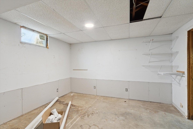 basement featuring a drop ceiling