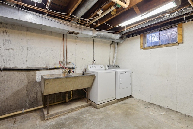 clothes washing area with sink and washer and clothes dryer