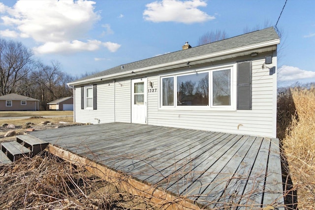 back of property with a wooden deck