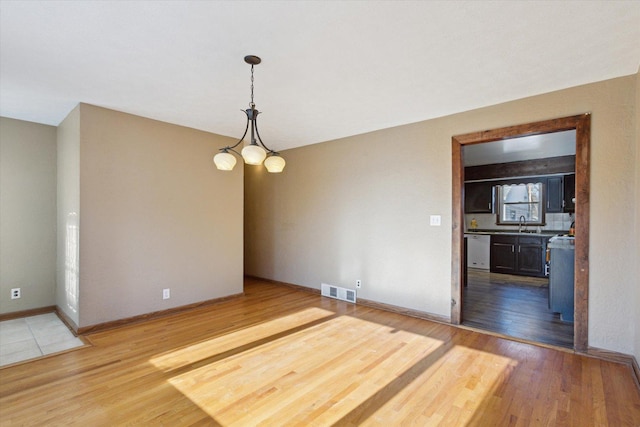 unfurnished dining area featuring wood-type flooring