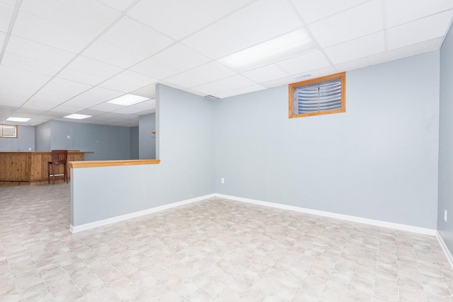 basement with a paneled ceiling