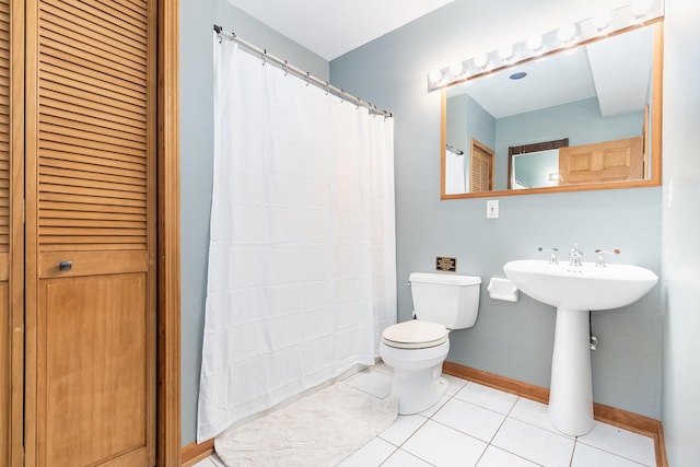 bathroom featuring toilet and tile patterned flooring