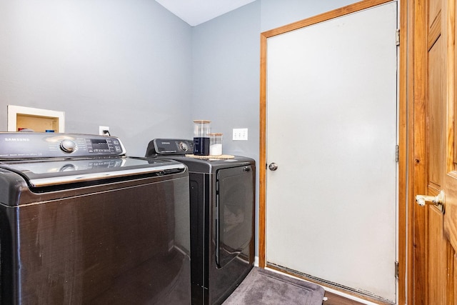 clothes washing area with washing machine and clothes dryer