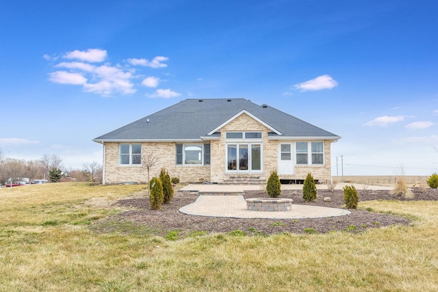 back of property featuring a yard, a fire pit, and a patio