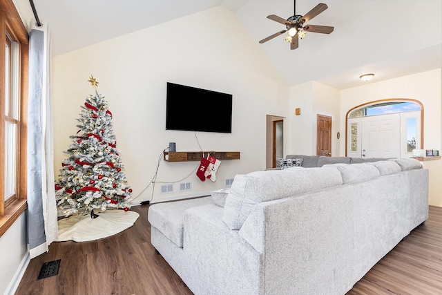 living room with hardwood / wood-style flooring, high vaulted ceiling, and ceiling fan