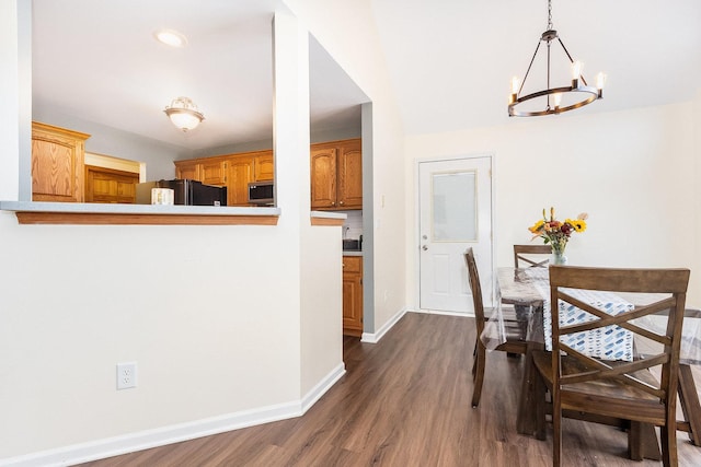 dining area featuring a chandelier and dark hardwood / wood-style floors