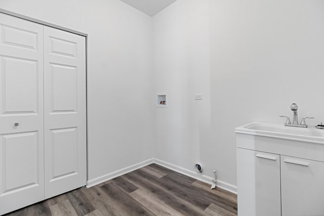 laundry room with hookup for a gas dryer, sink, washer hookup, and dark wood-type flooring