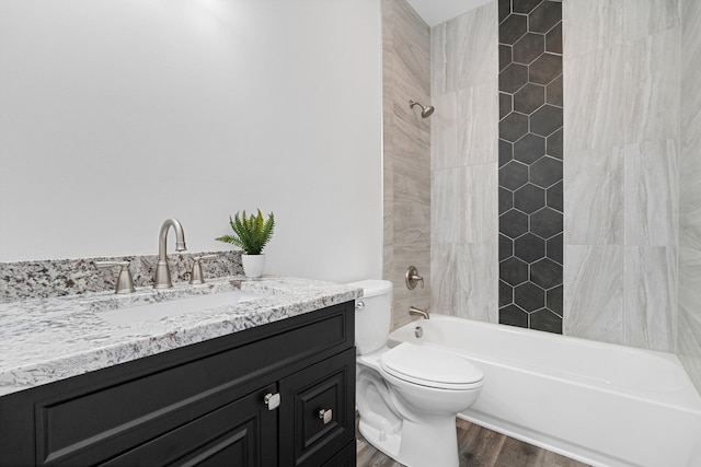 full bathroom with vanity, hardwood / wood-style flooring, tub / shower combination, and toilet