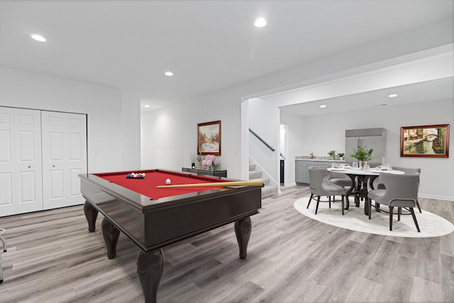 game room with pool table and light hardwood / wood-style floors