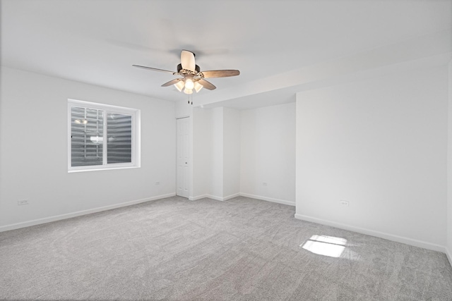 carpeted empty room featuring ceiling fan