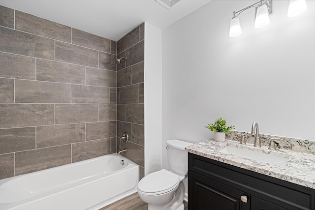 full bathroom with vanity, toilet, and tiled shower / bath