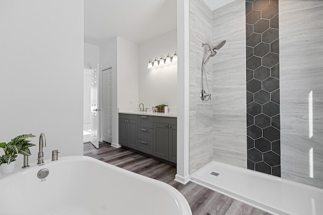 bathroom with vanity, separate shower and tub, and hardwood / wood-style floors