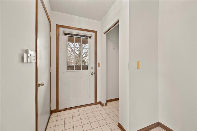 doorway to outside with light tile patterned floors