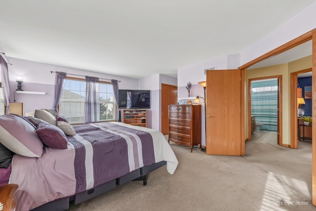 bedroom featuring light colored carpet