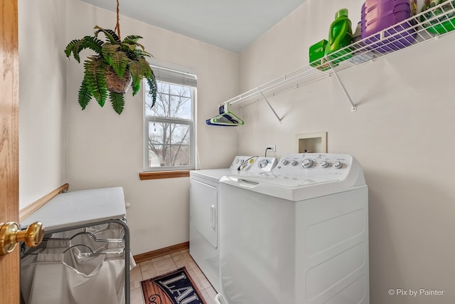 laundry room featuring light tile patterned flooring and washing machine and clothes dryer